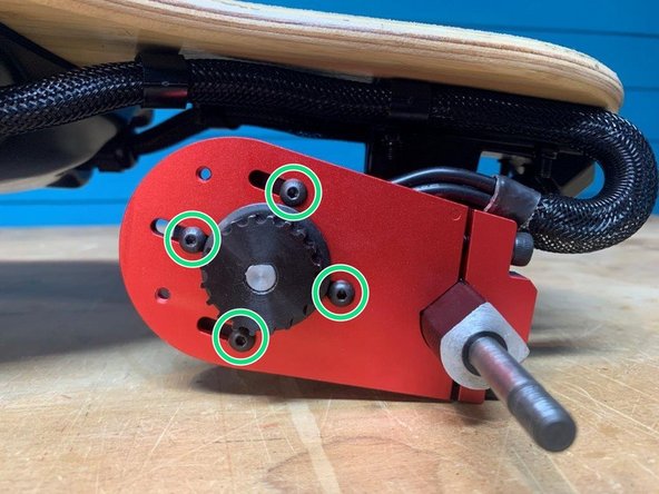 Loosen the four motor mount screws to add the wheel pulley