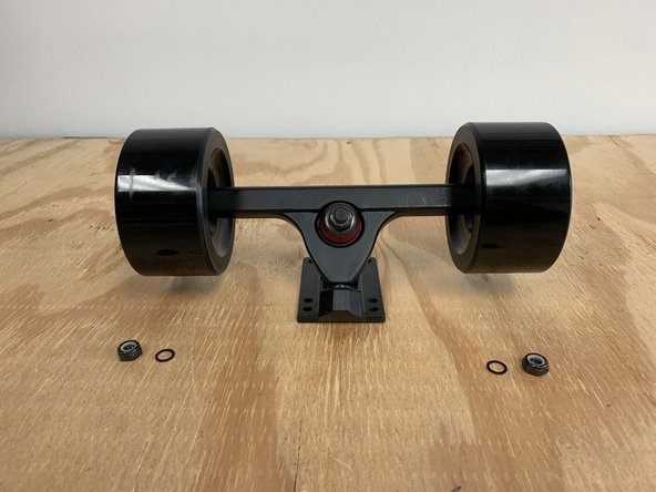 Remove one locknut and one washer from each side of the truck. Make sure there is still one washer on the truck