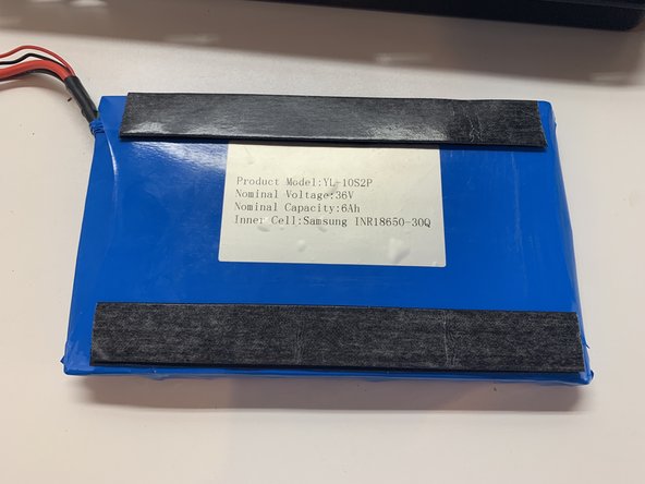 Gather the enclosure, battery, and battery velcro. Install the velcro on the  battery and then press firmly into the enclosure as shown