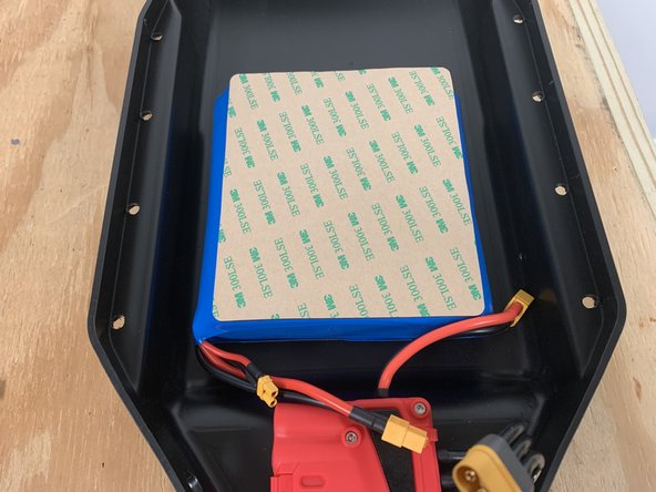 The10s3p battery has a wide side and a shorter side. Peel the paper backing off of the gasket on the wide side. Leave the paper on the short side