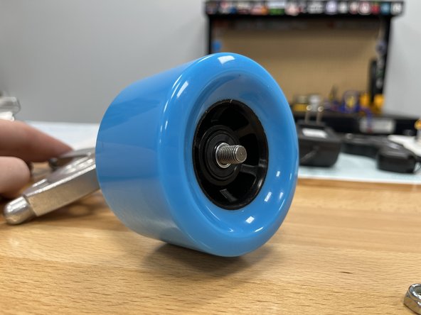 Slide the wheel onto the truck with the rounded and smooth side facing towards you. Knock the wheel back and forth if the bearing spacer is in the way and then wheel will not slide on