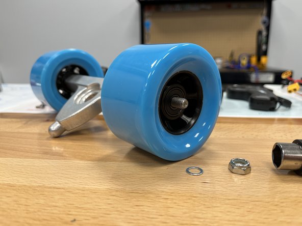 Slide the other wheel onto the hanger. Knock the wheel if necessary to align the bearing spacer.