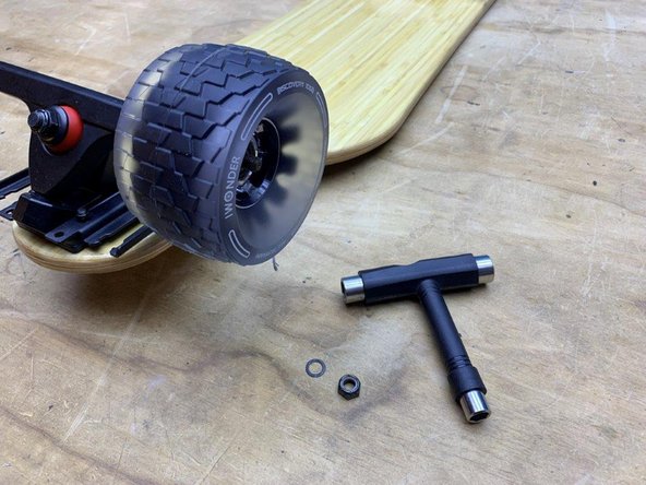 Slide the wheel onto the truck with the white letters facing outwards