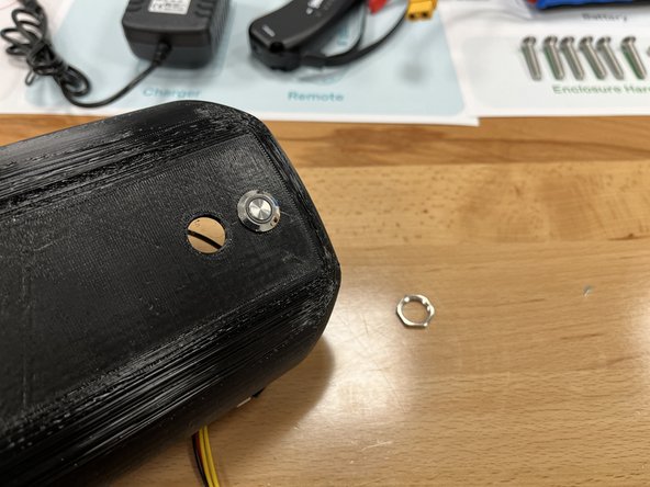 Push the switch through the top hole of the enclosure