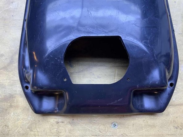 Cut the shape and two holes using your preferred method (Dremel, etc)