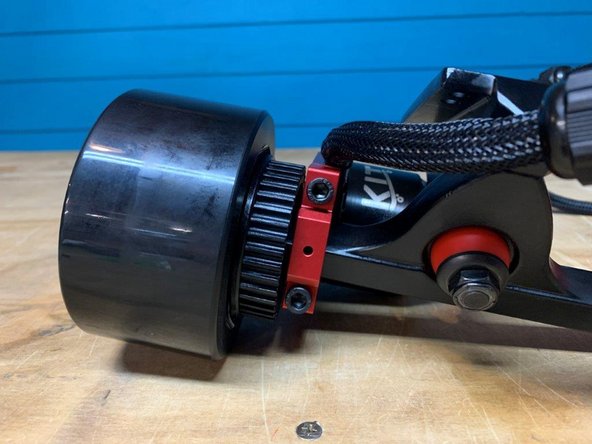 Slide the wheel onto the truck AND secure it with the washer and locknut you just took of