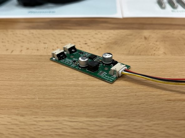 Plug the end without hot glue into the port on the light controller as shown