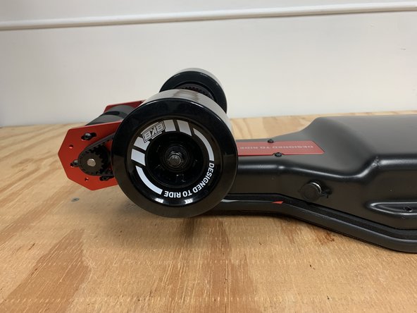 Position all of the wires as shown. Then use your hand to keep all wires in place and flip the enclosure over. Ensure you are flipping it the correct direction so the motor wires untangle themselves. They should now be straight directly from the motor and into the enclosure