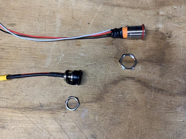 Remove the locknut from the switch and charge port