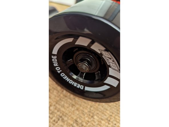 Tighten the lock nuts using the T-tool until they just touch the bearing. Then loosen the lock nuts a quarter turn of the tool. You should be able to move the wheel laterally on the axle by about 1mm.