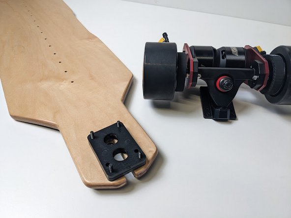 Repeat this process for the rear truck. Place bolts through the deck, then add your risers.