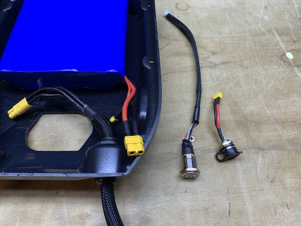 Remove the charge port and switch from the enclosure