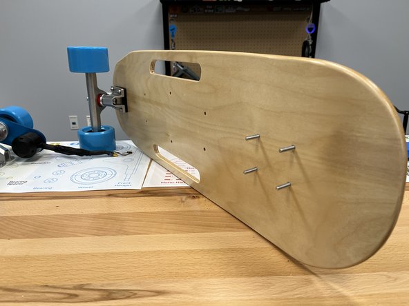 Flip the deck over and place the 4 other bolts through the rear truck holes