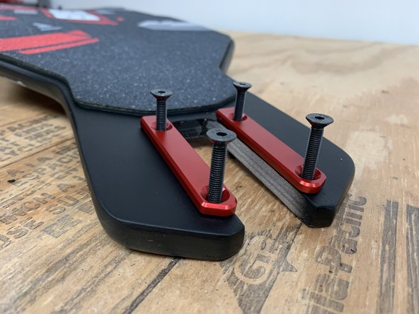 There are two different front rails, a left and a right. Take a left and right rail, place the truck bolts through them and then press the bolts through the front of the deck