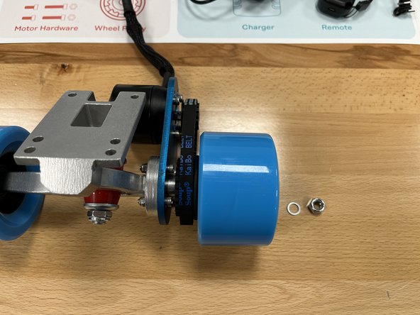 Slide the wheel + pulley onto the rear hanger and position the belt over both pulleys