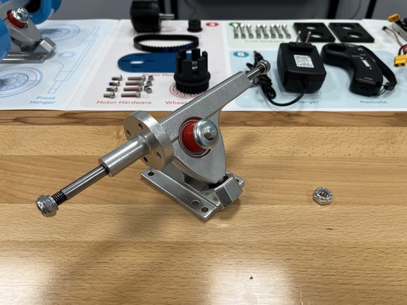 Place the red bushing back onto the truck with the smaller end toward the end of the bolt