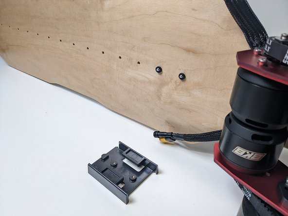 Place your bolts through the top of your deck in the center holes, closest to your motors.