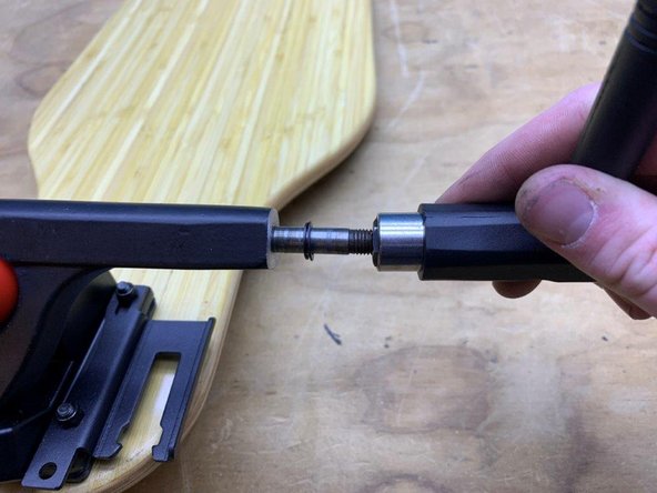 Use the black T-Tool to remove one locknut and one washer from the truck