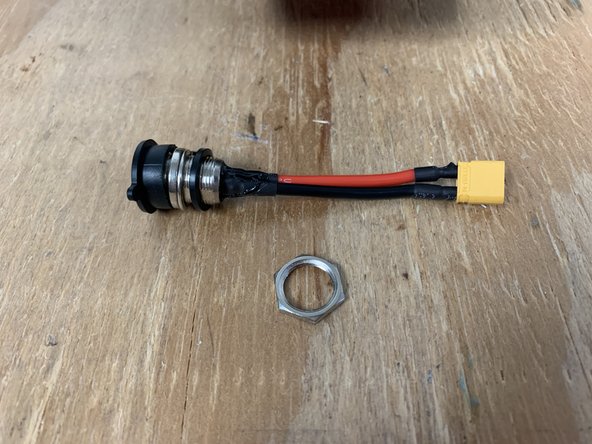 Remove the locknut from the charge port