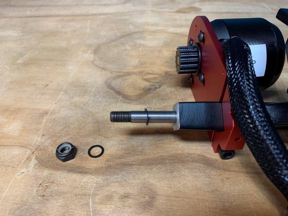 Remove one washer and the locknut from the left side of the truck