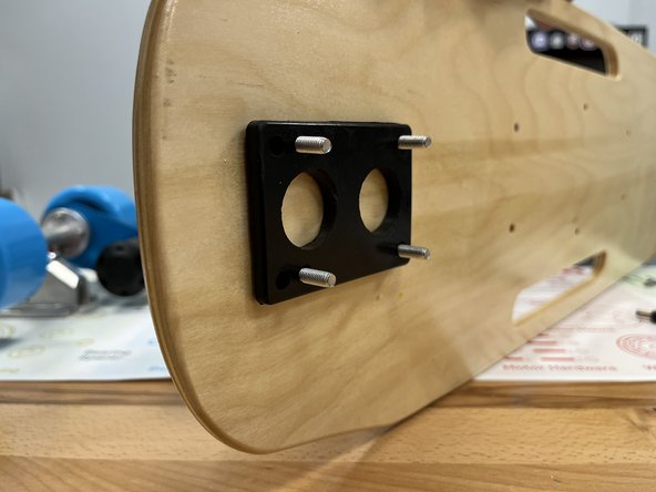 Place 4 truck bolts through the front holes in the deck