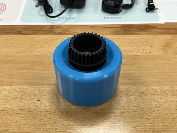 Place the wheel pulley into the wheel on the flat side with the lines (not the rounded front).