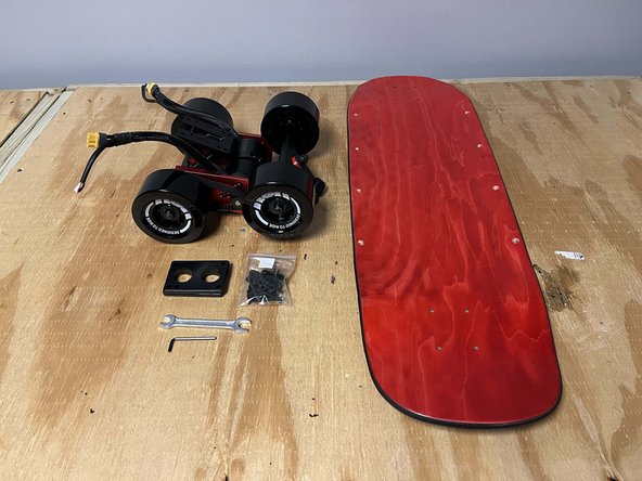 Gather the front truck, rear truck, deck, truck hardware, risers, T Tool, and 3mm Allen wrench