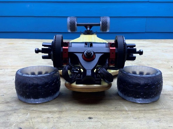 Position the board so you have access to the rear truck. Gather the other two wheels and T-Tool