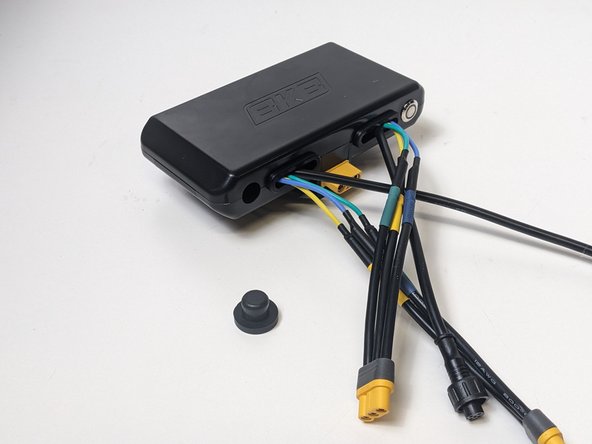 Work your rubber stopper into the round port opposite of the ESC's switch.