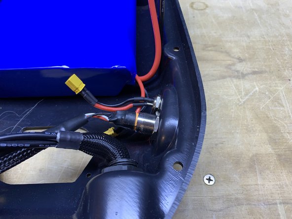 Remove the charge port and switch from the enclosure