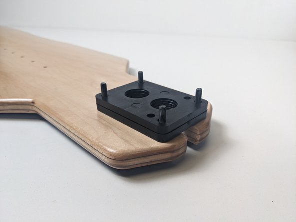 Add your riser's to the underside of the deck over the bolts.