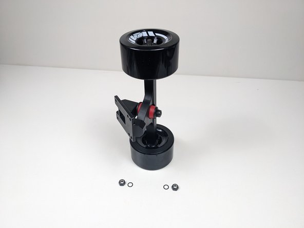 Remove one locknut and one washer from each side of the truck. Make sure there is still one washer on the truck