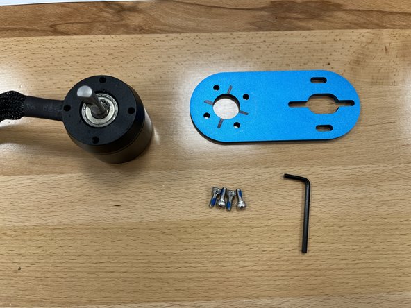 Gather the motor mount, motor, short M4x10 bolts, and larger 3mm Allen Wrench from Section 3