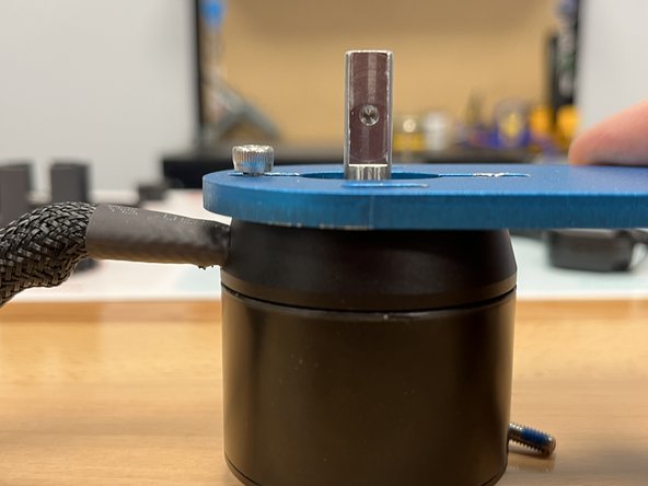 Place the motor mount onto the motor as shown. The wire should exit directly left of the motor mount, and you should NOT see the black marks.