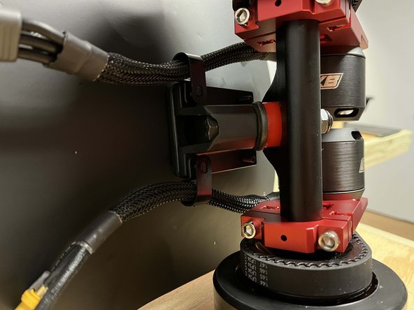 Place the drivetrain onto the bolts with the motor mounts facing the rear