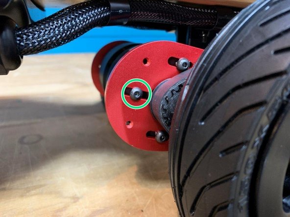 While holding it in this position, tighten the one exposed motor bolt