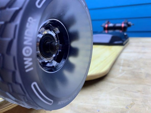 Slide one washer (that was removed earlier) back onto the truck