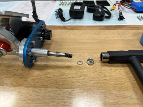 Use the T-Tool to remove the locknut and 1 silver spacer from the rear hanger