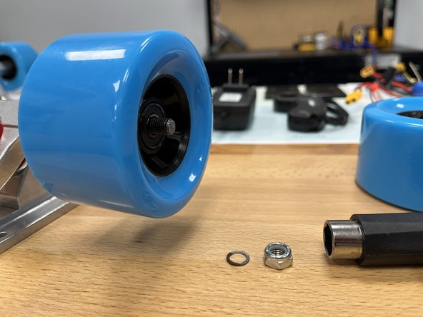 Slide the wheel onto the truck with the rounded and smooth side facing towards you. Knock the wheel back and forth if the bearing spacer is in the way and then wheel will not slide on