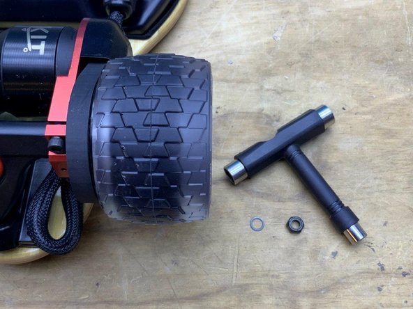 Slide the wheel onto the truck with the white letters facing outward