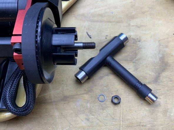 Remove one washer and locknut from the back truck using the T-Tool