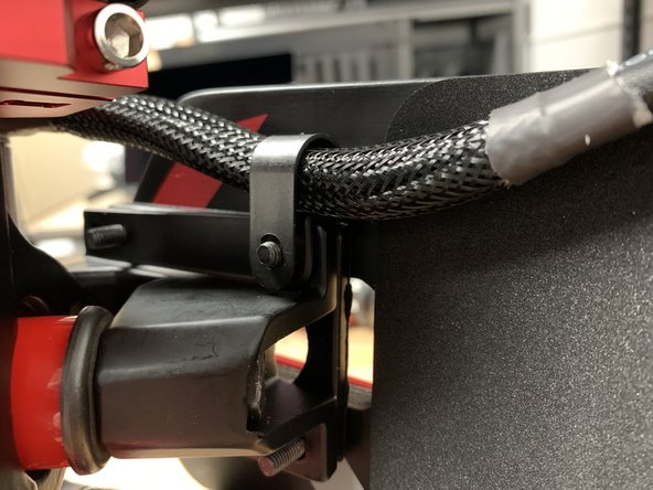 Add a wire clip to each motor and orientate them as shown. Then slide  a wire clip over each of the two inner bolts