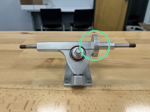 Remove the locknut, silver washer, and one red bushing