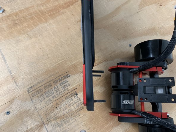 Repeat this process for the rear truck. Place bolts through the top rails and then through the deck