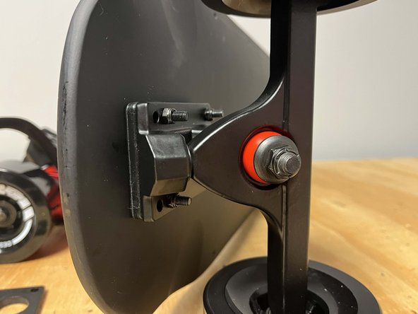 Secure the front truck to the deck with 4x locknuts