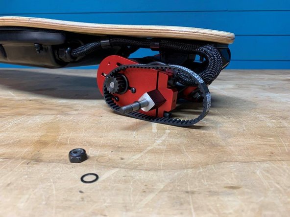 Then, remove the wheel and add a belt around the motor pulley