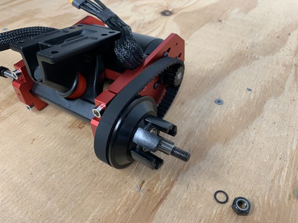 Place the belt over the motor pulley. You will need to slide the motor all the way forward and the four bolts securing the motor will need to be loose to accomplish this