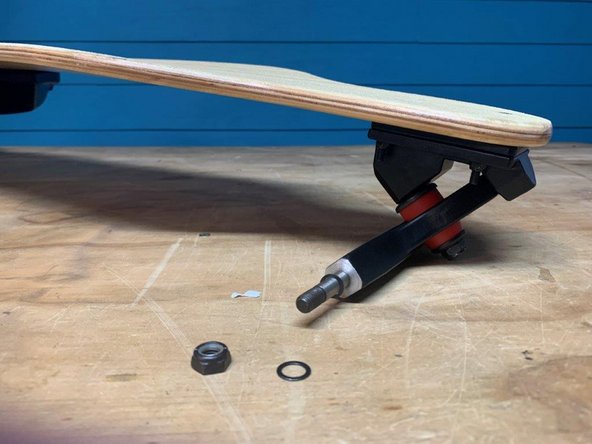 Then, remove one washer and locknut from the front truck