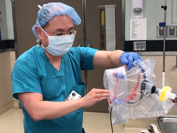 Reach into clean side of bag with clean hand and grasp loop.