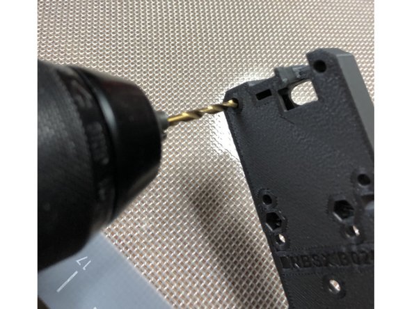 Clear out each 3mm screw hole with a 3 mm drill bit to make bolt insertion easier.